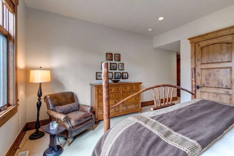 This spacious guest suite features a reading nook and natural wood trim.