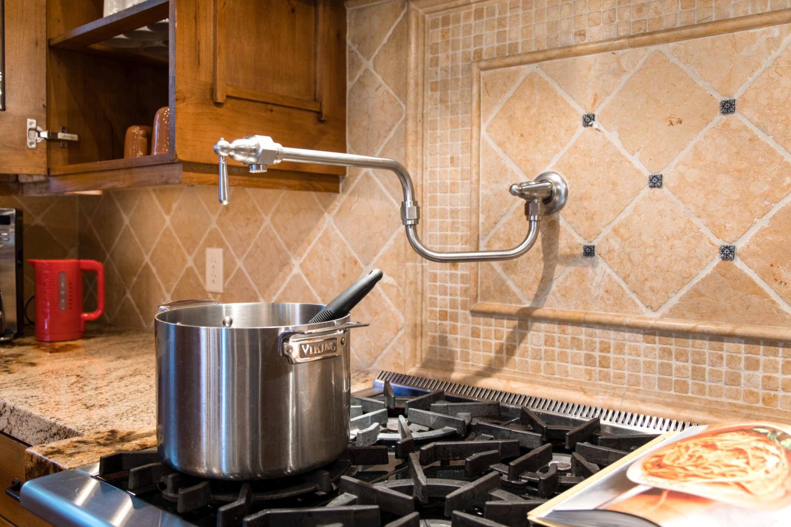 Six-burner range and prep sink make this a dream kitchen for cooking with a view.