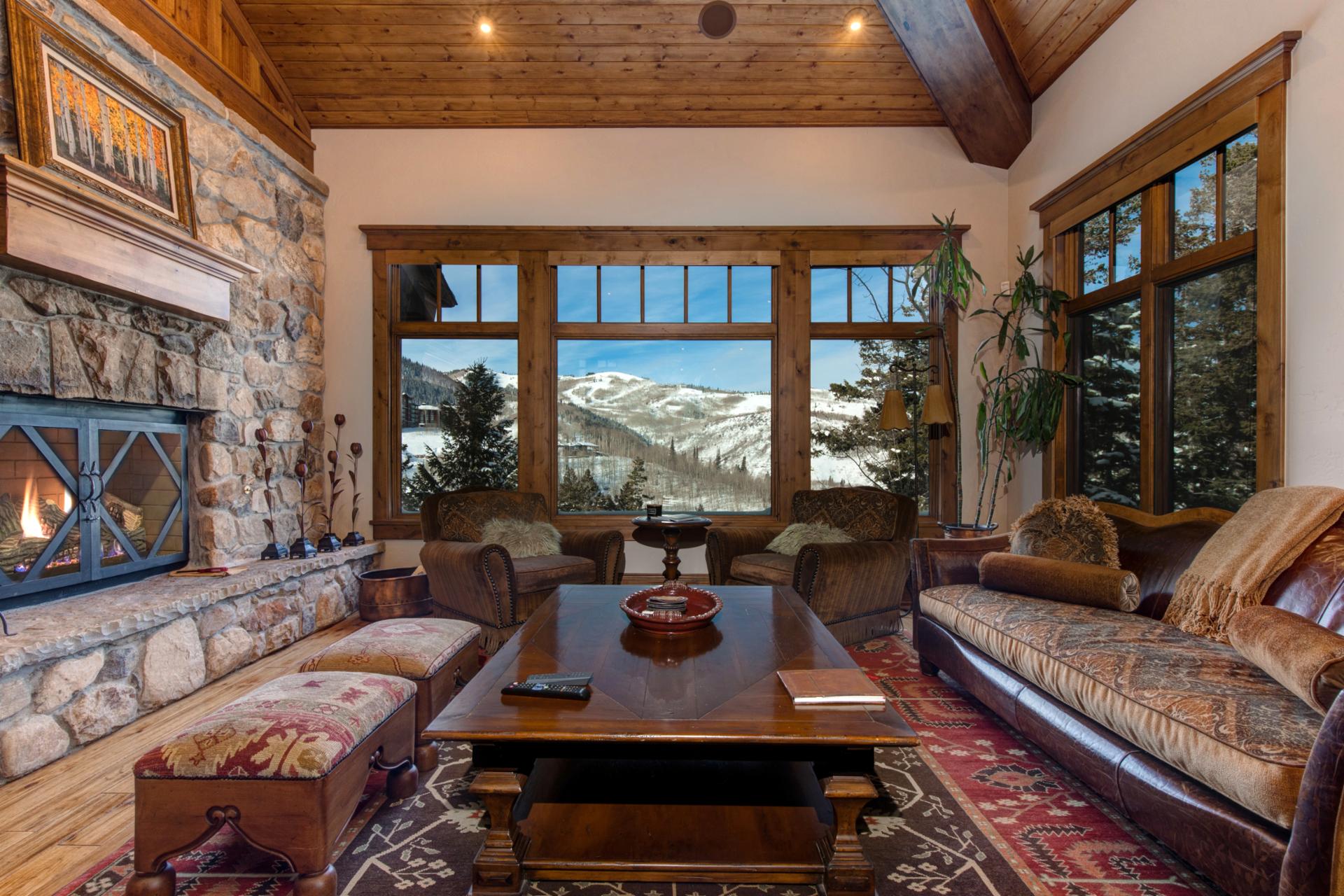 A second living area offers panoramic views, vaulted ceilings, and access to the deck.