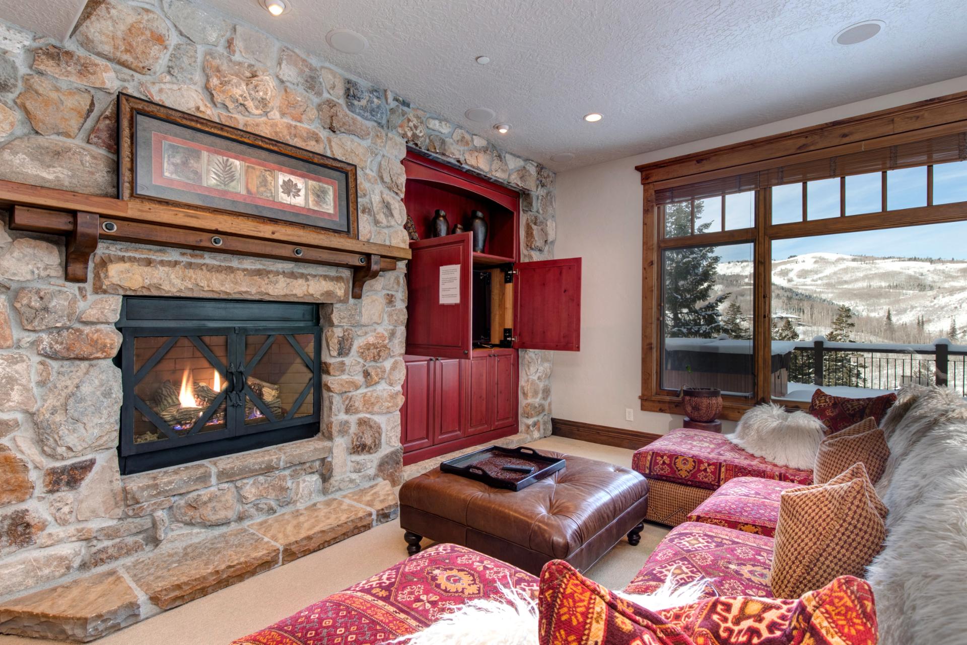 Stone fireplace and built-in shelves anchor this inviting family room.