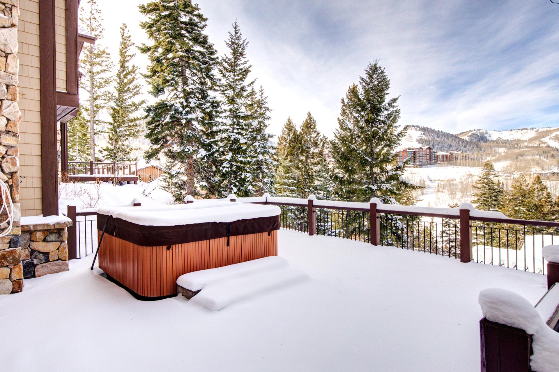 Watch the snow fall while soaking in your private deckside hot tub.