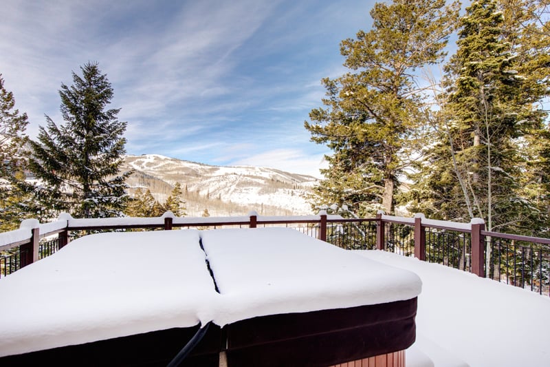 Hot tub with pine views and open skies.
