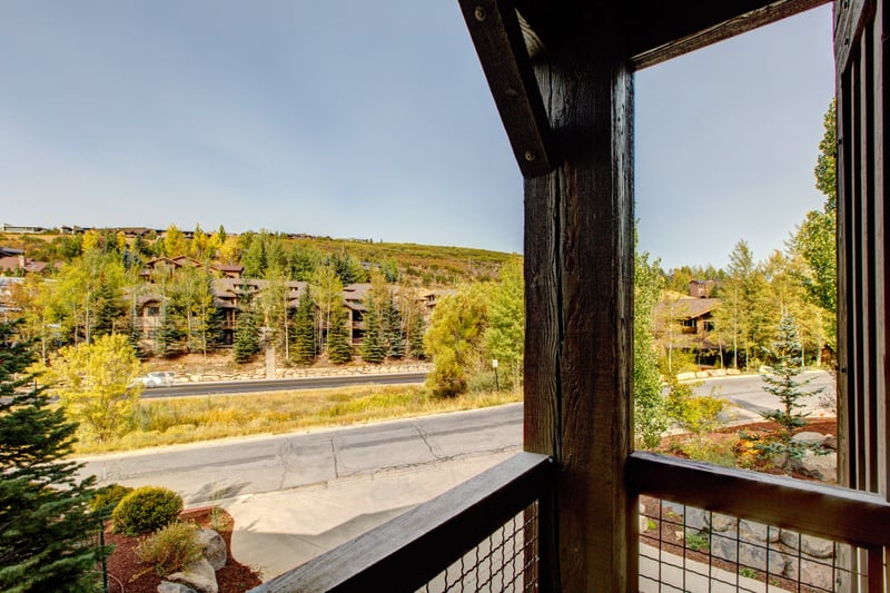 Enjoy peaceful balcony views of pine trees, hillside homes, and a quiet mountain road—perfect for morning coffee or golden hour.
