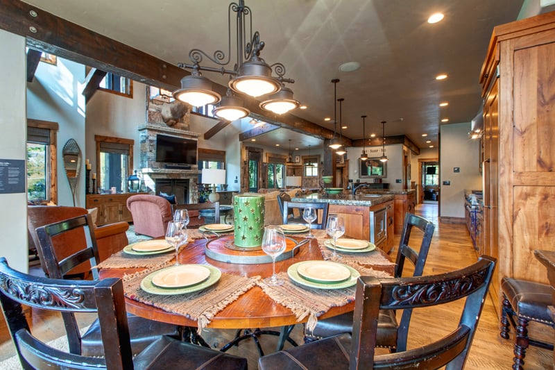 Share meals in your cozy dining area for six with lodge-style lighting, wood accents, and open flow to the kitchen and living room.