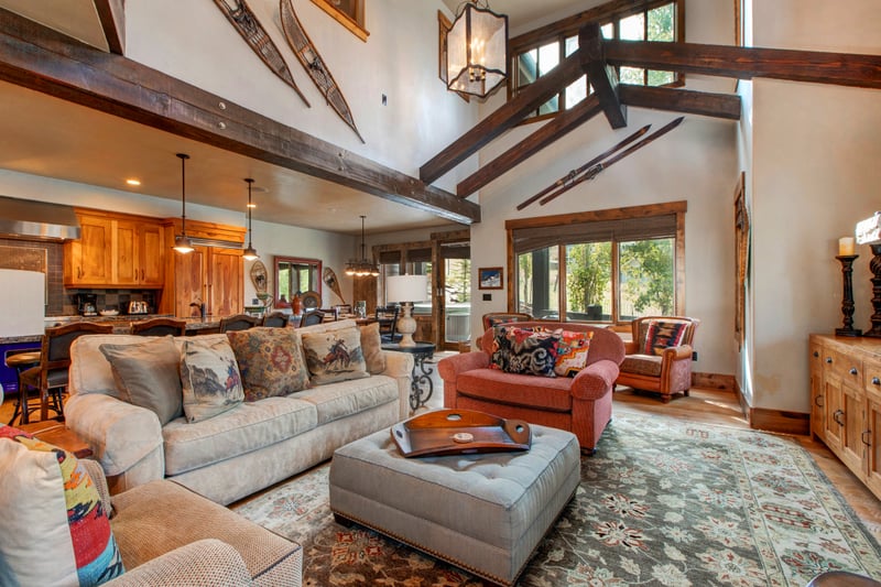 Gather in the main living room with vaulted ceilings, stone fireplace, and ample seating for relaxed evenings or group movie nights.