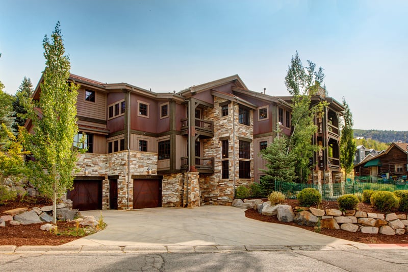 Arrive to your luxurious mountain townhome with stone accents, timber framing, and a wide driveway for easy unloading.