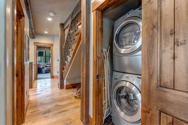 Tucked in the hall, your laundry nook includes a stacked washer/dryer and rustic wood doors for seamless convenience.