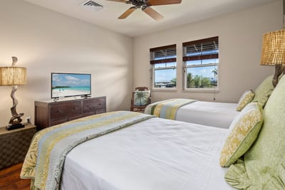 Chic tropical guest suite with warm tones, twin comfort, and a touch of island sophistication