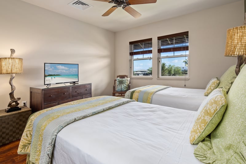 Chic tropical guest suite with warm tones, twin comfort, and a touch of island sophistication