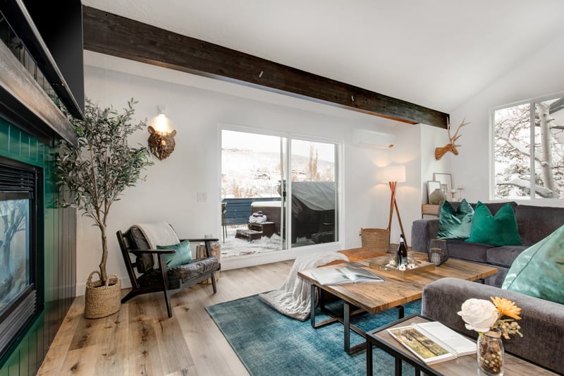 Bright and inviting living area with large windows and designer lighting.