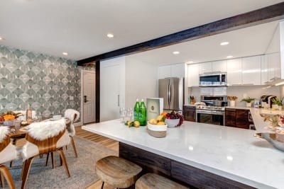 Crisp design, island seating, and an open layout make this kitchen a favorite gathering spot.