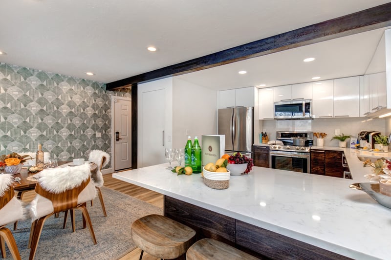 Crisp design, island seating, and an open layout make this kitchen a favorite gathering spot.