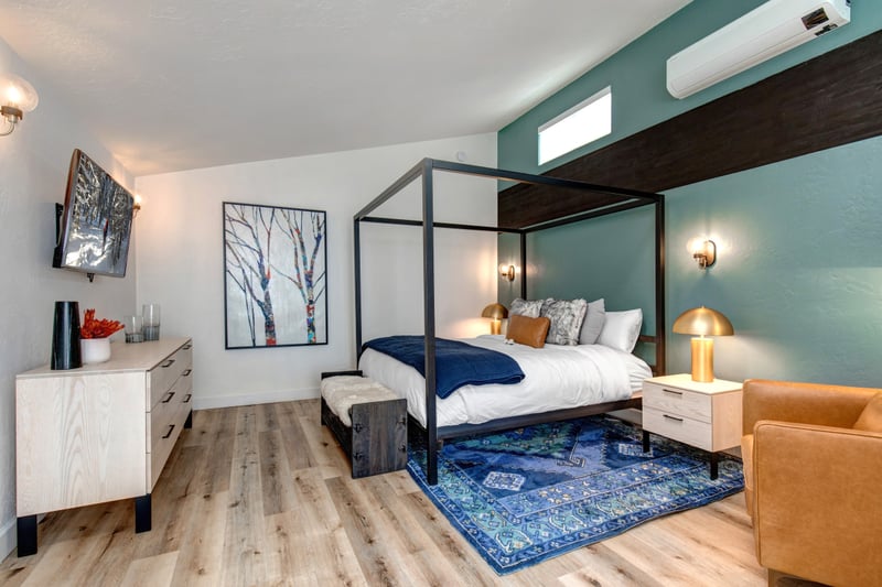 Modern and serene, this King loft suite offers privacy and a cozy retreat under vaulted ceilings.