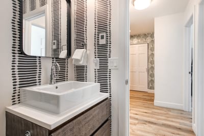 Modern vanity and stylish finishes round out this full shared bath.