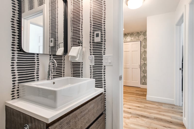 Modern vanity and stylish finishes round out this full shared bath.