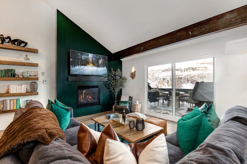 Corner windows and a modern fireplace highlight this vibrant living space with room for everyone.