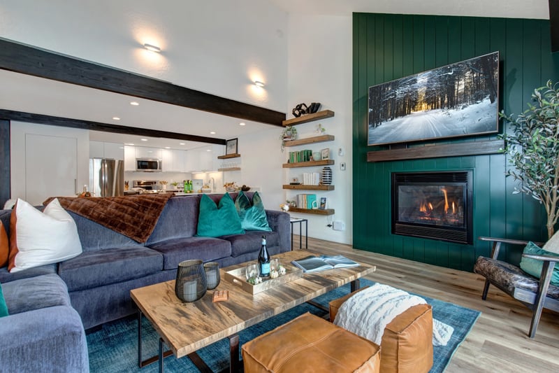 Gather around the fireplace in your cozy living room with smart TV, modern accents, and easy access to dining.