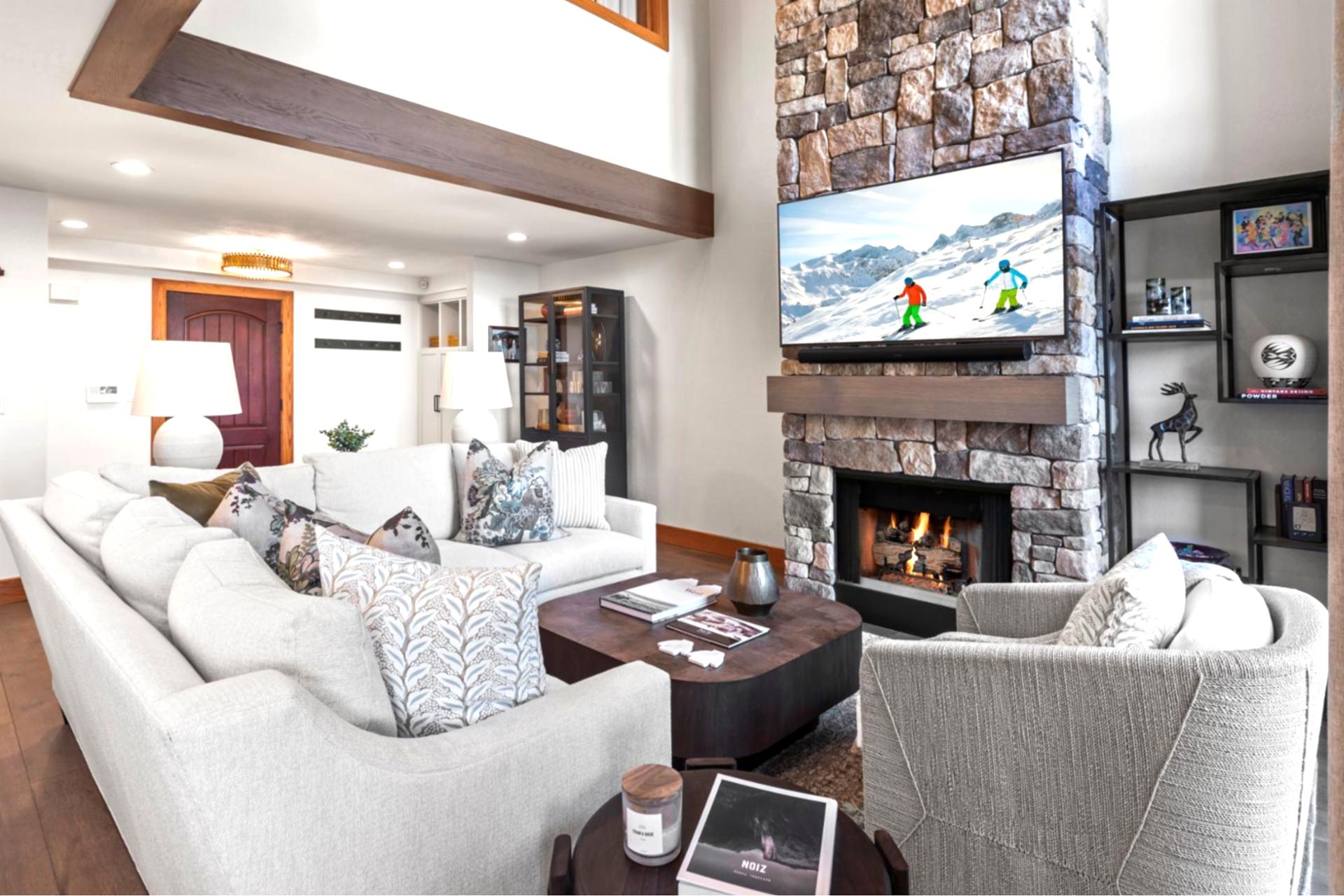 Chic mountain living with stone fireplace, plush furnishings, and après-ski ambiance.