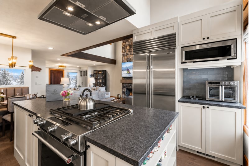 Chef’s kitchen with professional stainless appliances, granite countertops, and open-concept flow.