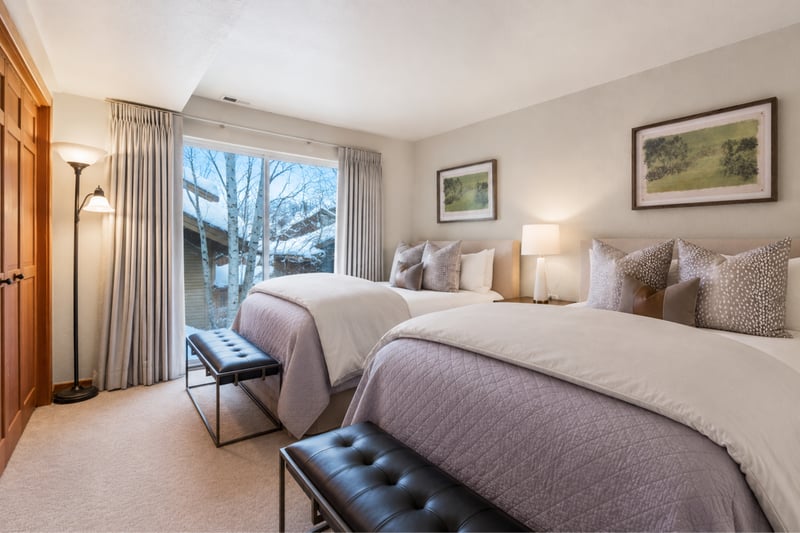 Two double bed guest room featuring landscaping views, natural light, and stylish cozy linens.