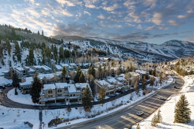 Charming alpine neighborhood beneath snowy slopes and vibrant winter skies.