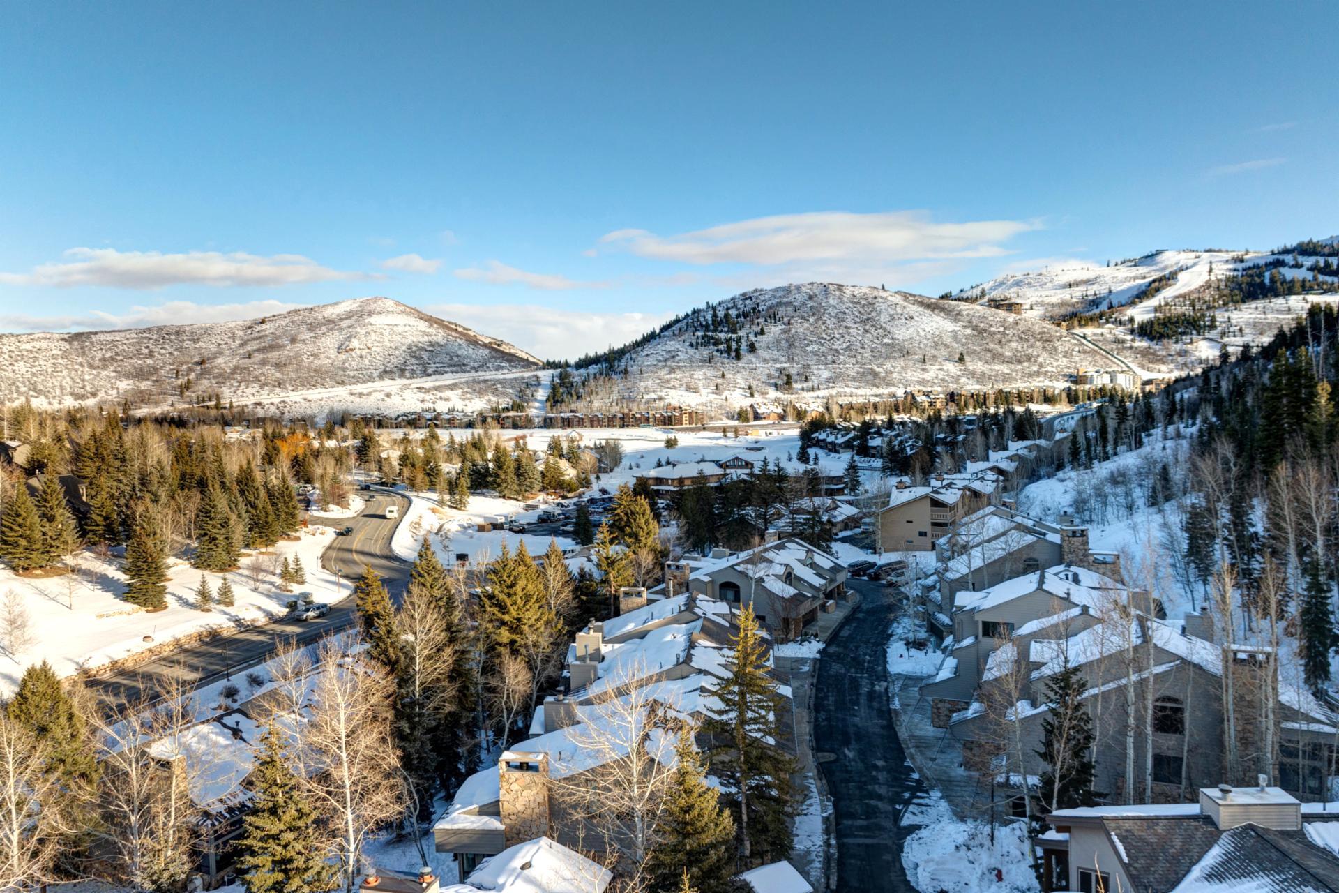 Scenic view of Deer Valley village nestled in snowy mountains under a crystal-clear winter sky.