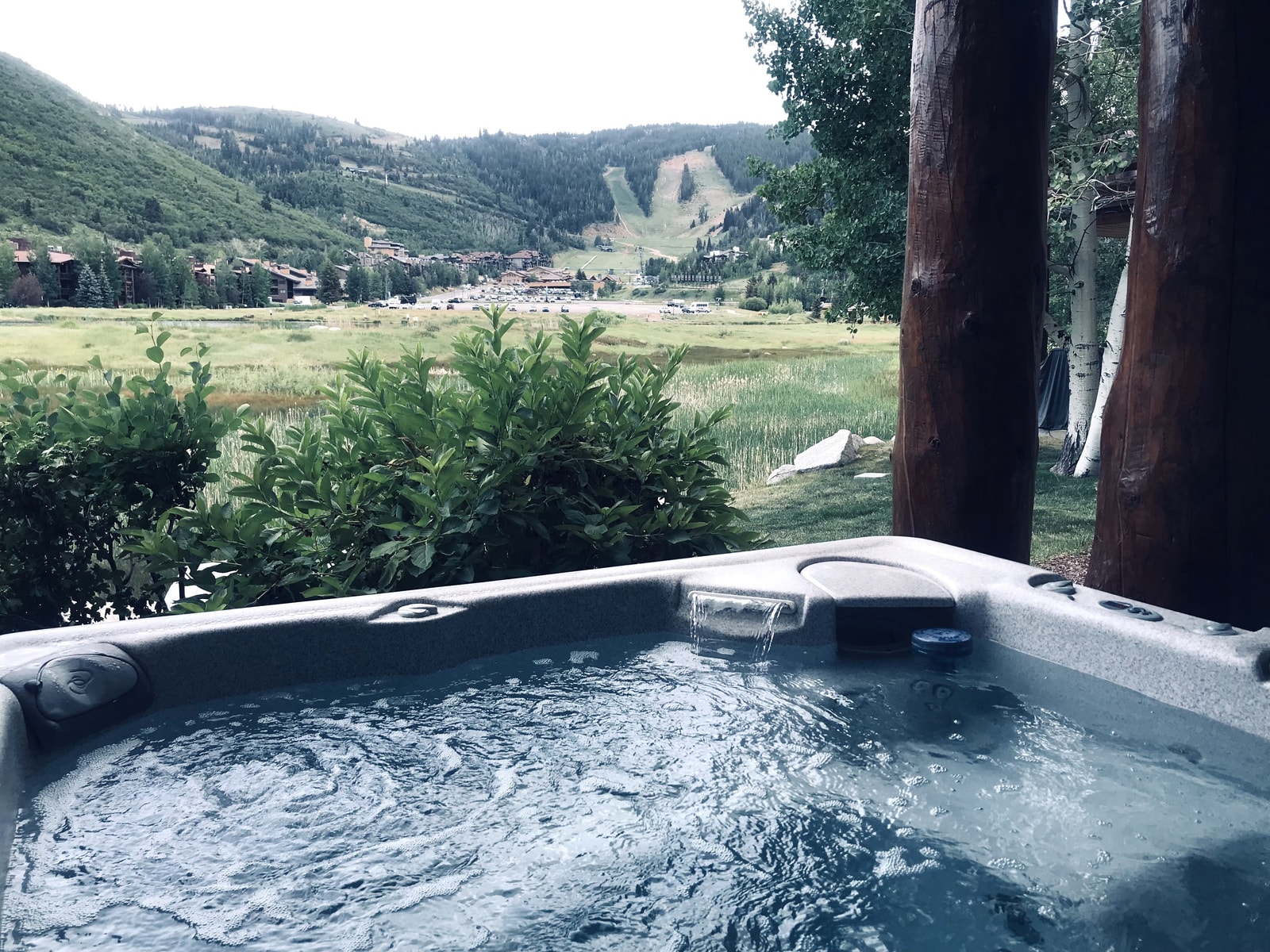 A peaceful mountain backdrop surrounds your bubbling spa, open year-round for relaxation.