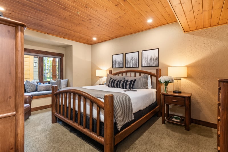 Unwind in your spacious primary suite with a King bed, warm wood finishes, and peaceful mountain tones.