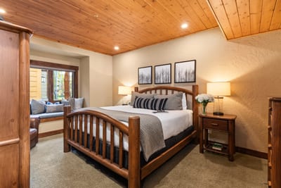 Unwind in your spacious primary suite with a King bed, warm wood finishes, and peaceful mountain tones.