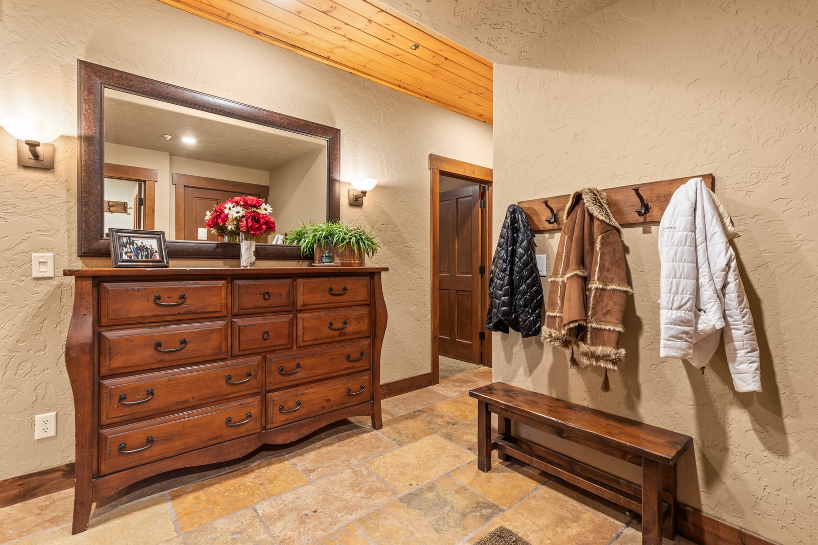 Drop gear and get organized in your mudroom with hooks, bench, and easy access to the rest of the home.