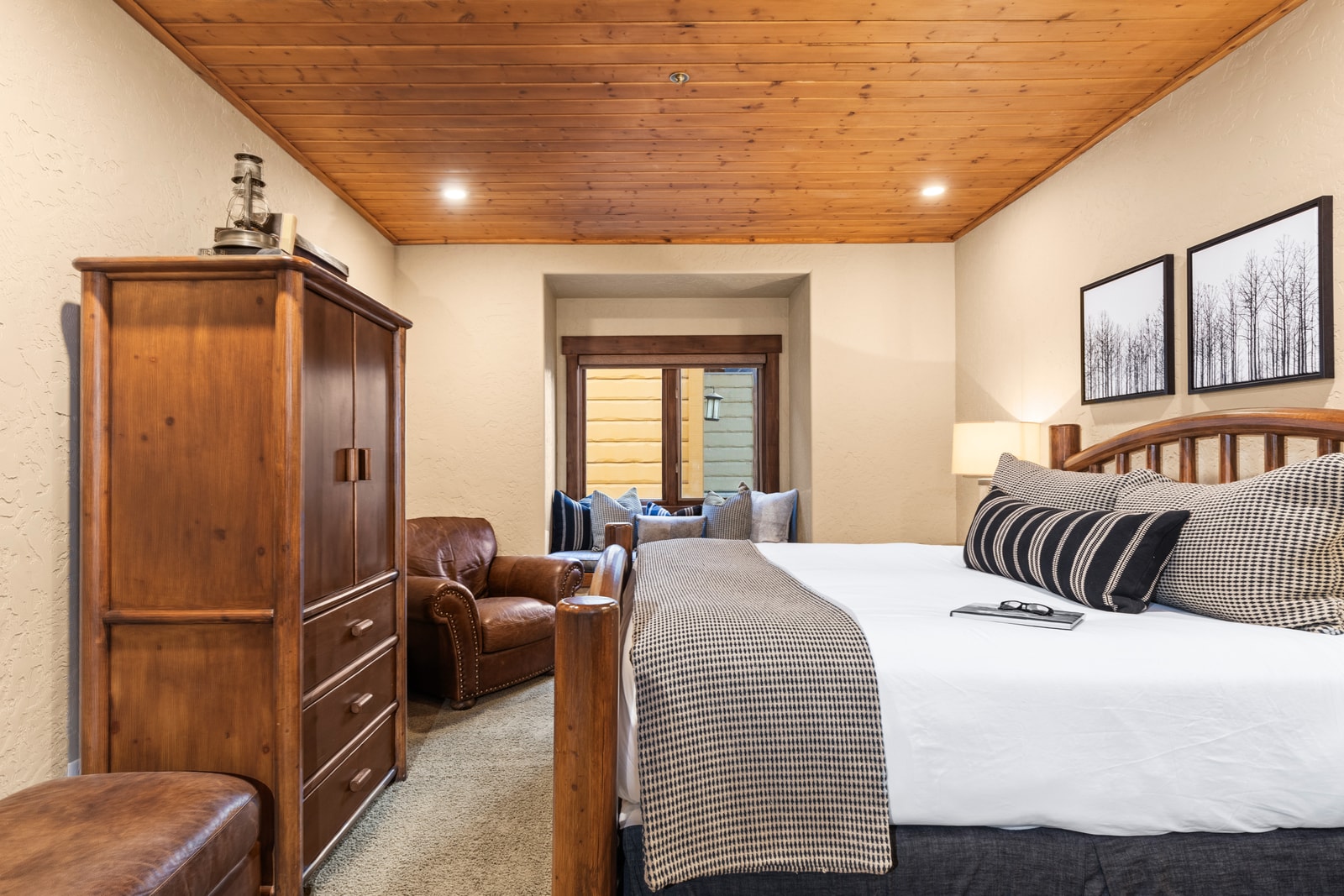 Primary bedroom with King bed and en suite bath offers comfort, privacy, and direct access to the rest of the home.