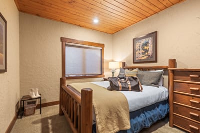 Your second bedroom features a Queen bed, dresser, and wood ceilings for a warm, restful vibe.