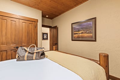 Another angle of the Queen room shows cozy bedding and mountain-inspired artwork.