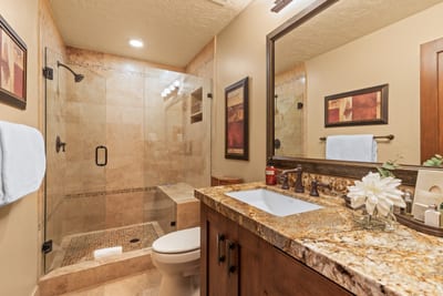 Guest bath with walk-in shower, granite vanity, and L’Occitane products keeps every guest comfortable.