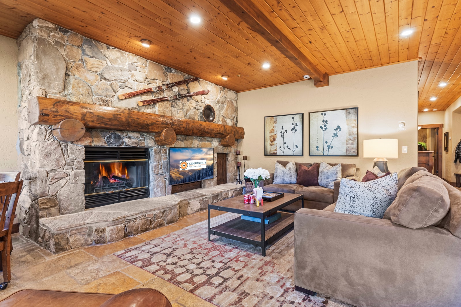 Gather in the cozy living room with a stone fireplace, plush seating, and a Queen sofa sleeper for extra guests.
