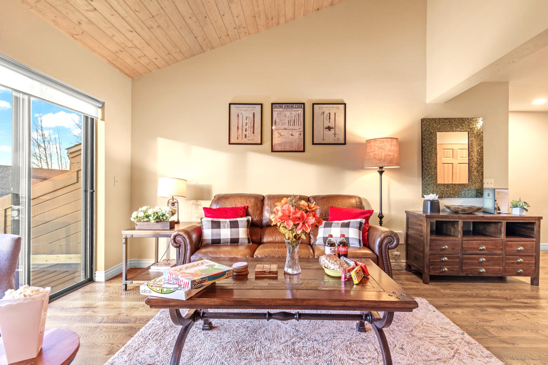 Vaulted wood ceiling with large windows allowing bright and warming sunshine to cascade in