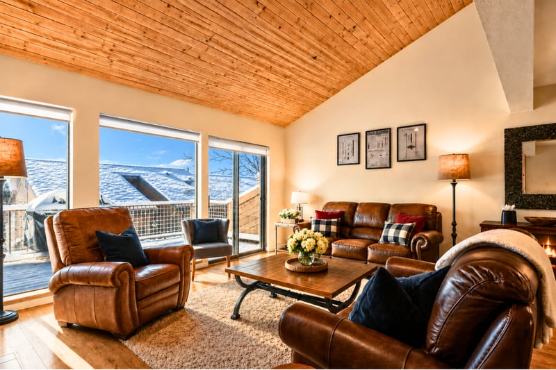 An entire wall of windows to watch the snow fall on blistery winter days, while you stay warm, cuddled up by the fire.
