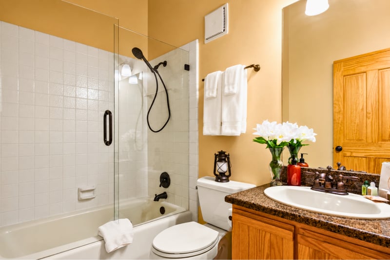 Guest bathroom with glass-enclosed tub/shower with oil-rubbed bronze fixtures