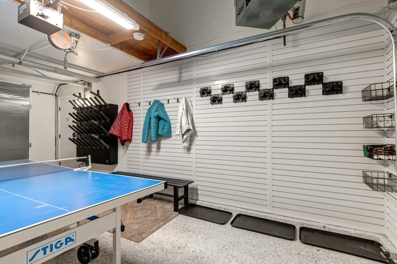 Garage game room with ping pong table and boot dryer racks for post-ski gear storage