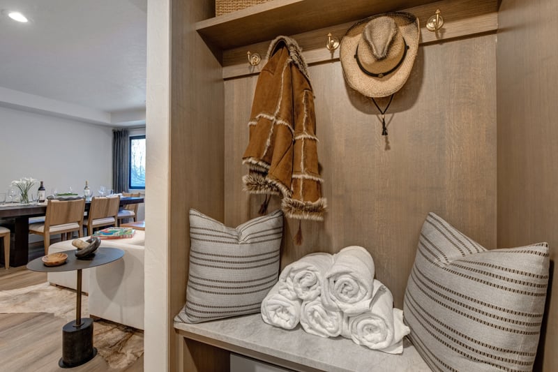 Mudroom nook with coat hooks and fresh rolled towels for stashing ski gear after a day on the mountain