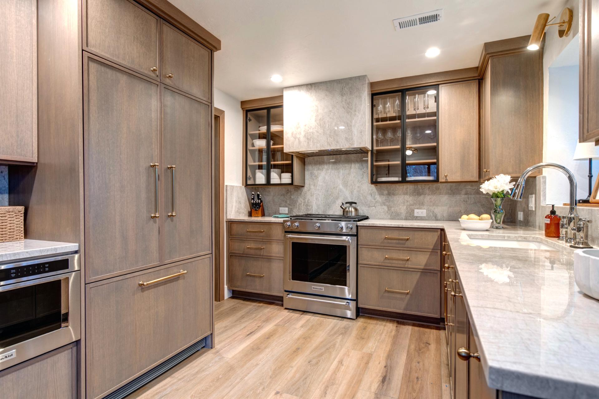 Handcrafted wooden built-in cabinets paired with stainless steel appliances, perfect for preparing vacation meals.