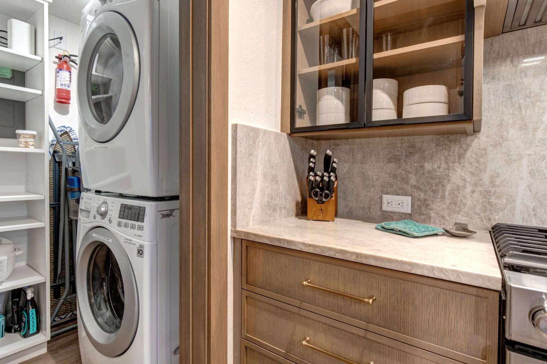 Stackable laundry room located in a closed off room from the kitchen