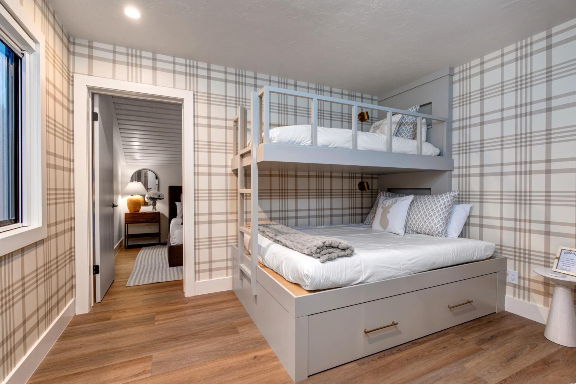 Bunk bed has a queen bed on the bottom, trundle pull out, and twin bed on top (please keep weight under 50lbs)