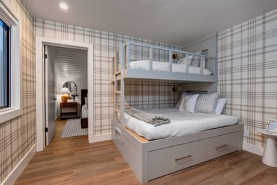 Bunk bed has a queen bed on the bottom, trundle pull out, and twin bed on top (please keep weight under 50lbs)