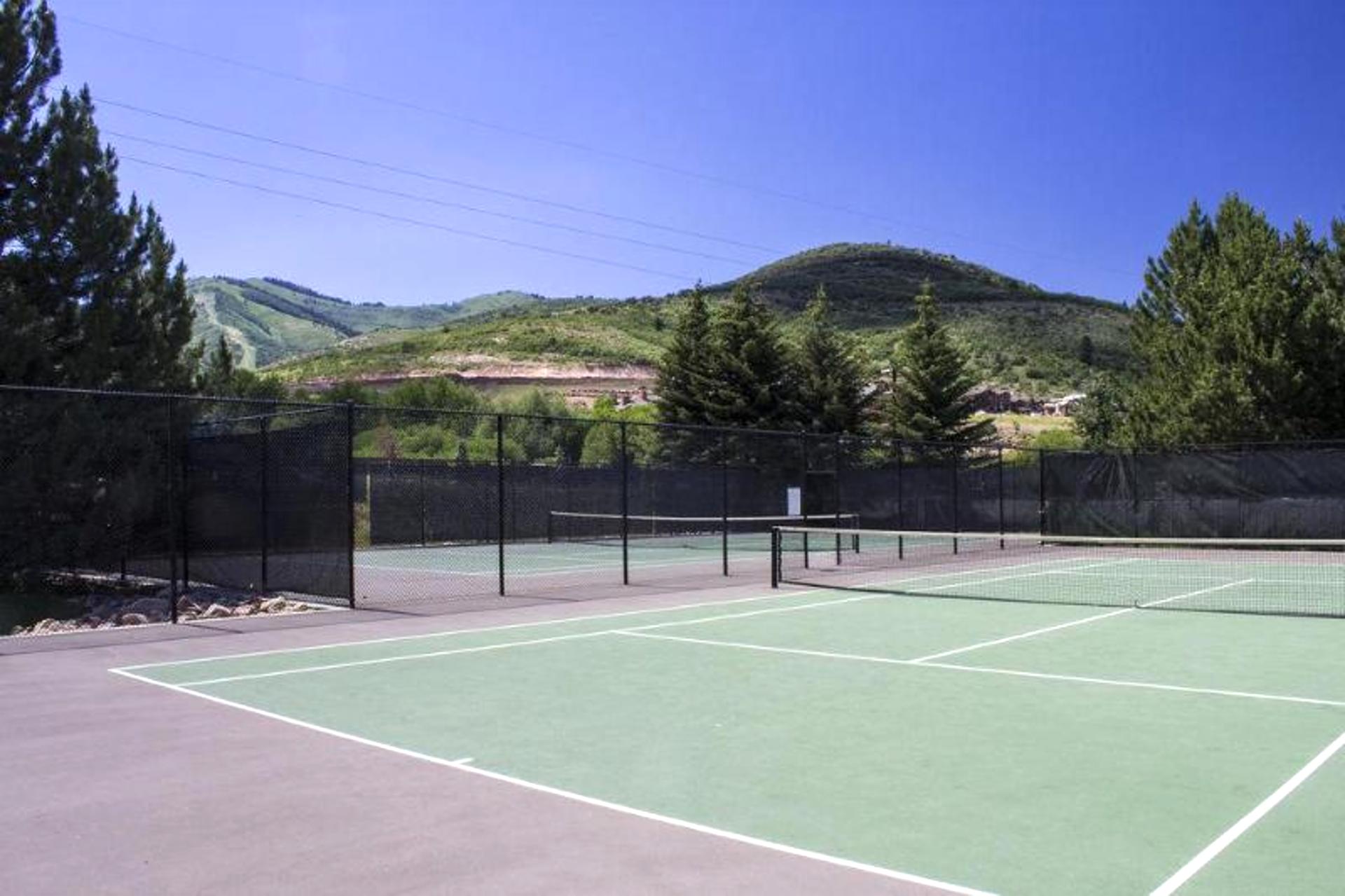 Challenge friends to a game on the private tennis court.