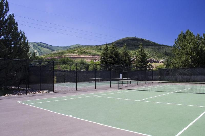 Challenge friends to a game on the common area tennis court.