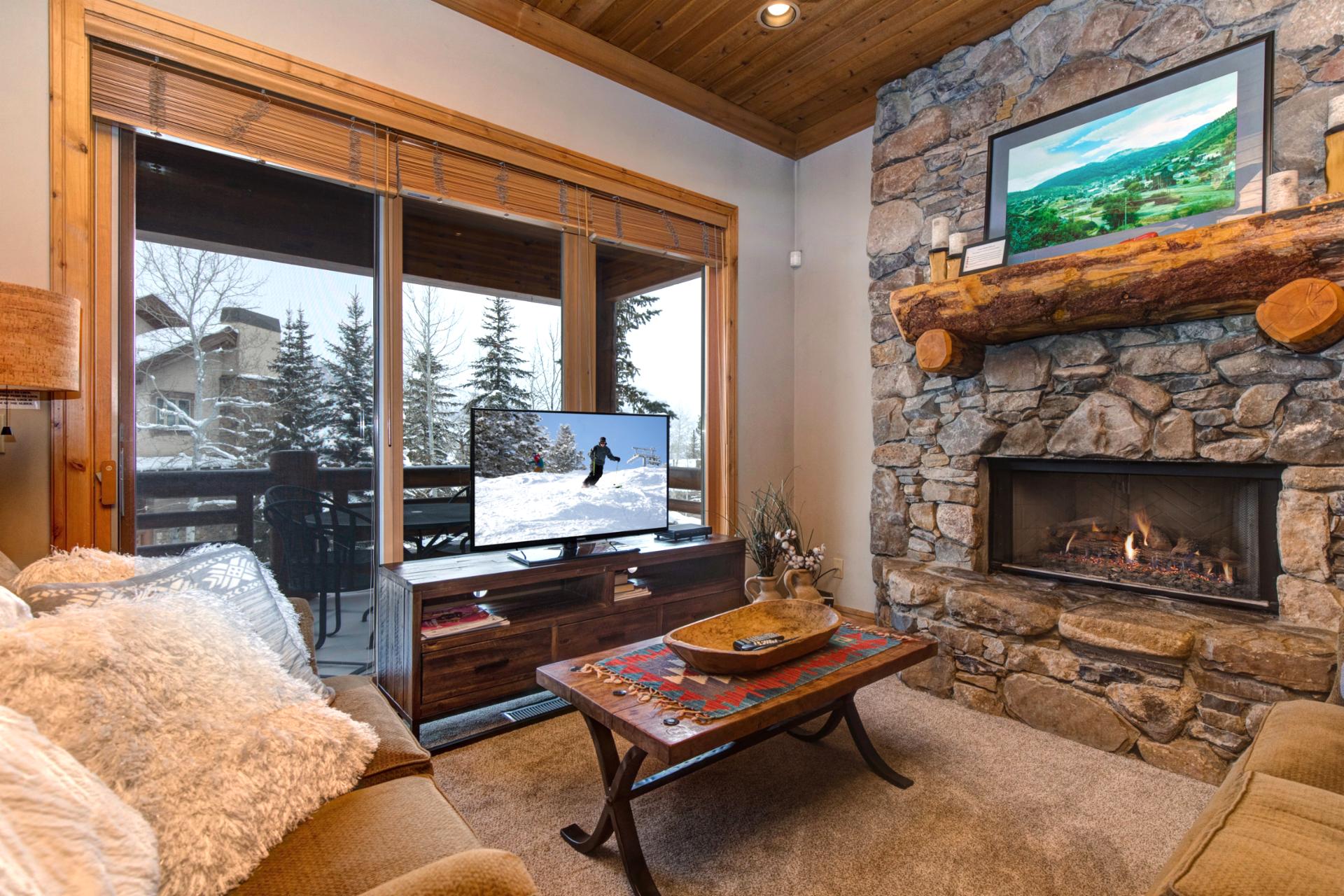 Step into comfort with stylish seating, a gas fireplace, and large windows that bring the forest view right to your gathering space.