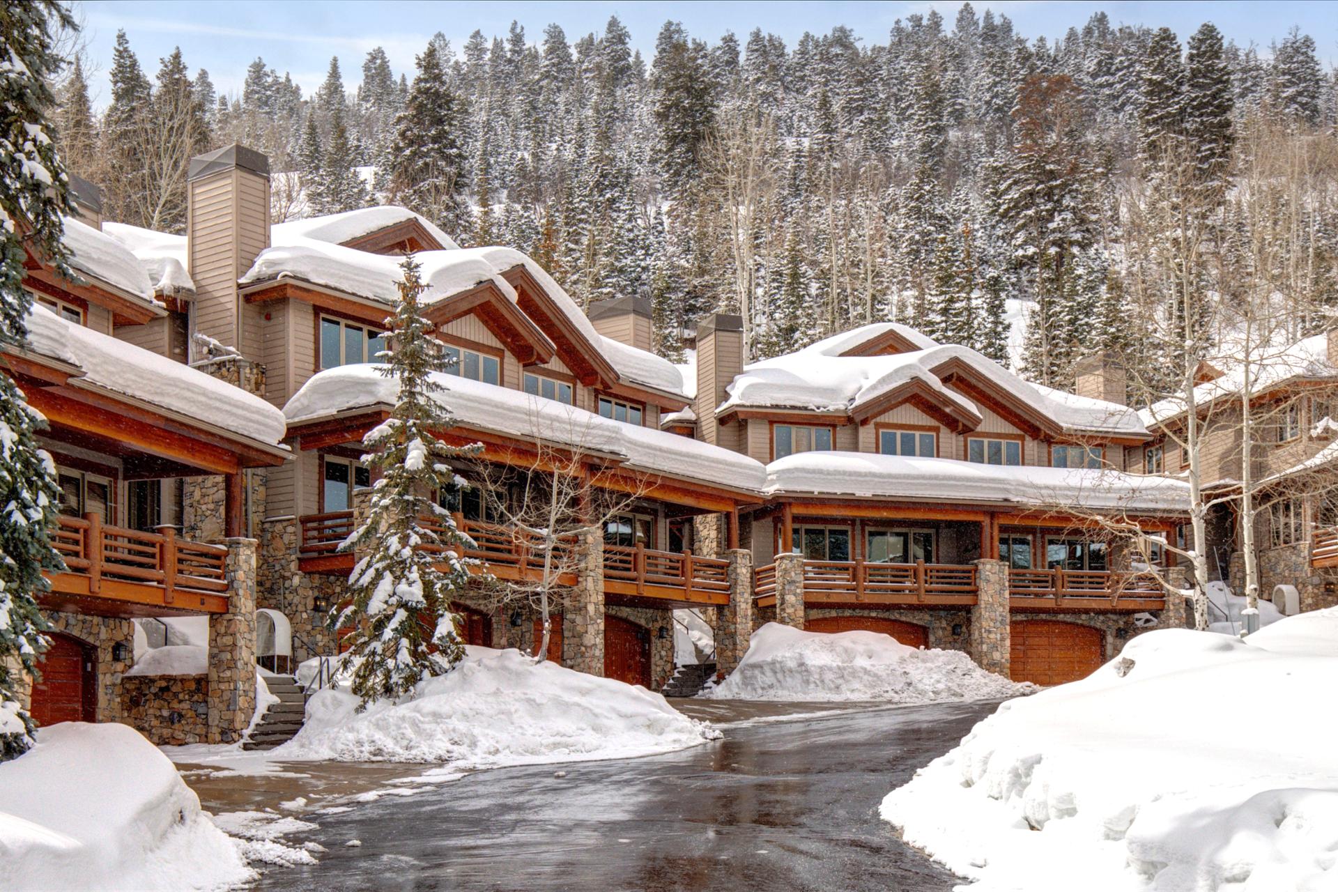 Winter brings postcard-perfect charm to the exterior, where tall trees and snow-covered rooftops set the scene.