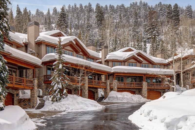 Winter brings postcard-perfect charm to the exterior, where tall trees and snow-covered rooftops set the scene.
