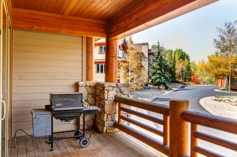 Grill dinner on your private deck with forest views and fresh alpine air, just outside the main living space.